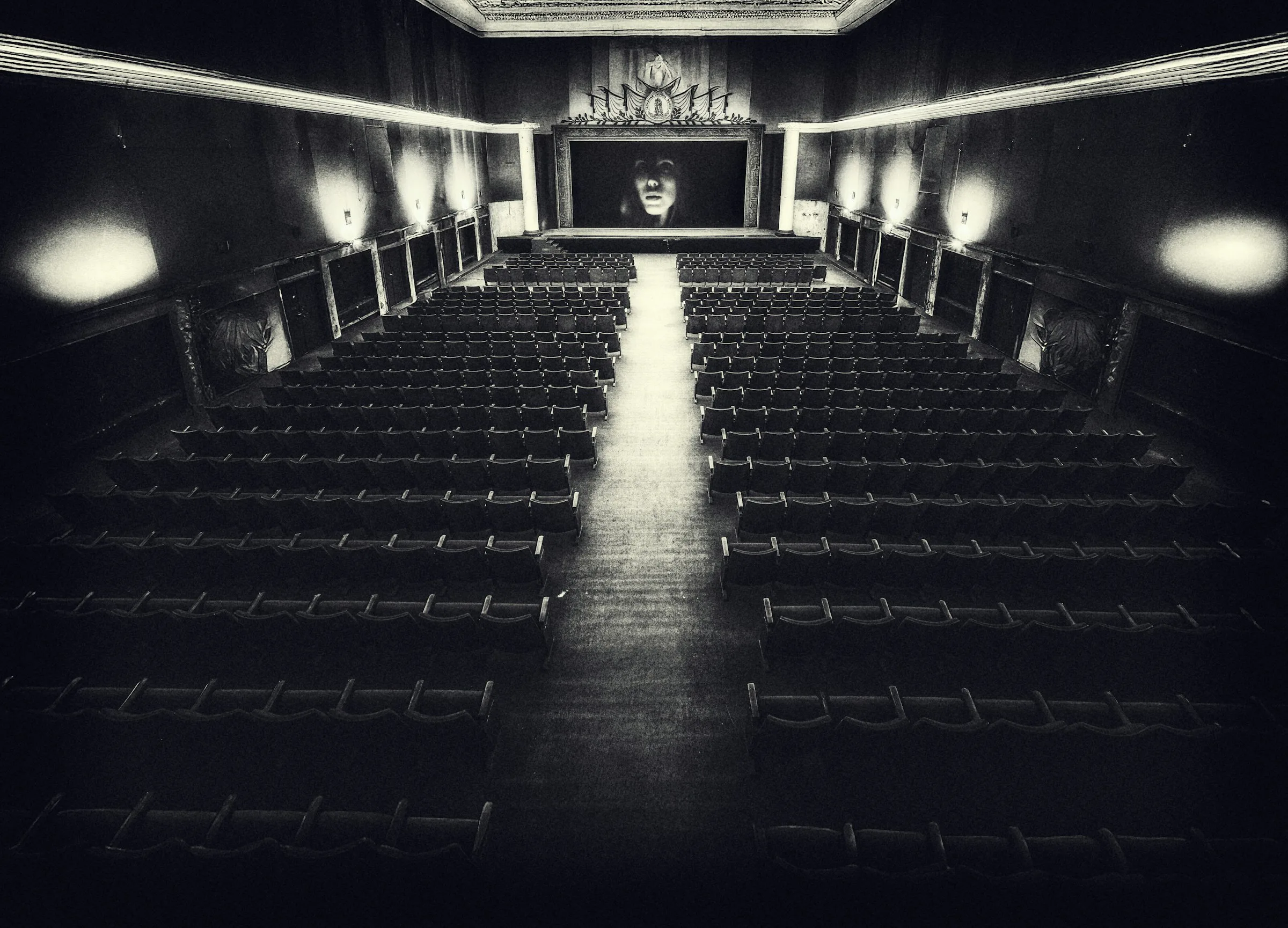Empty cinema auditorium seen from the back rows