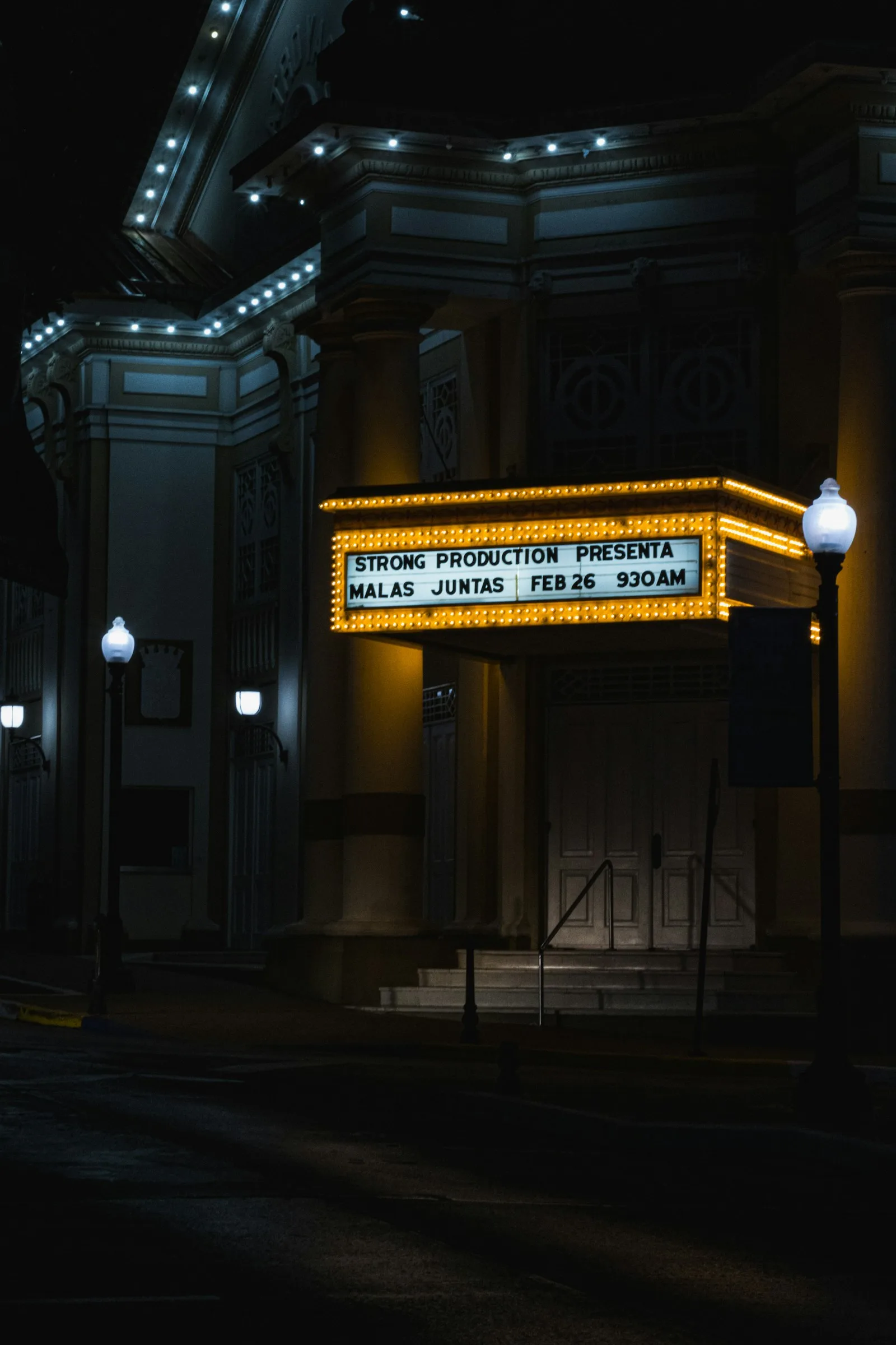 Queue at a cinema entrance at night