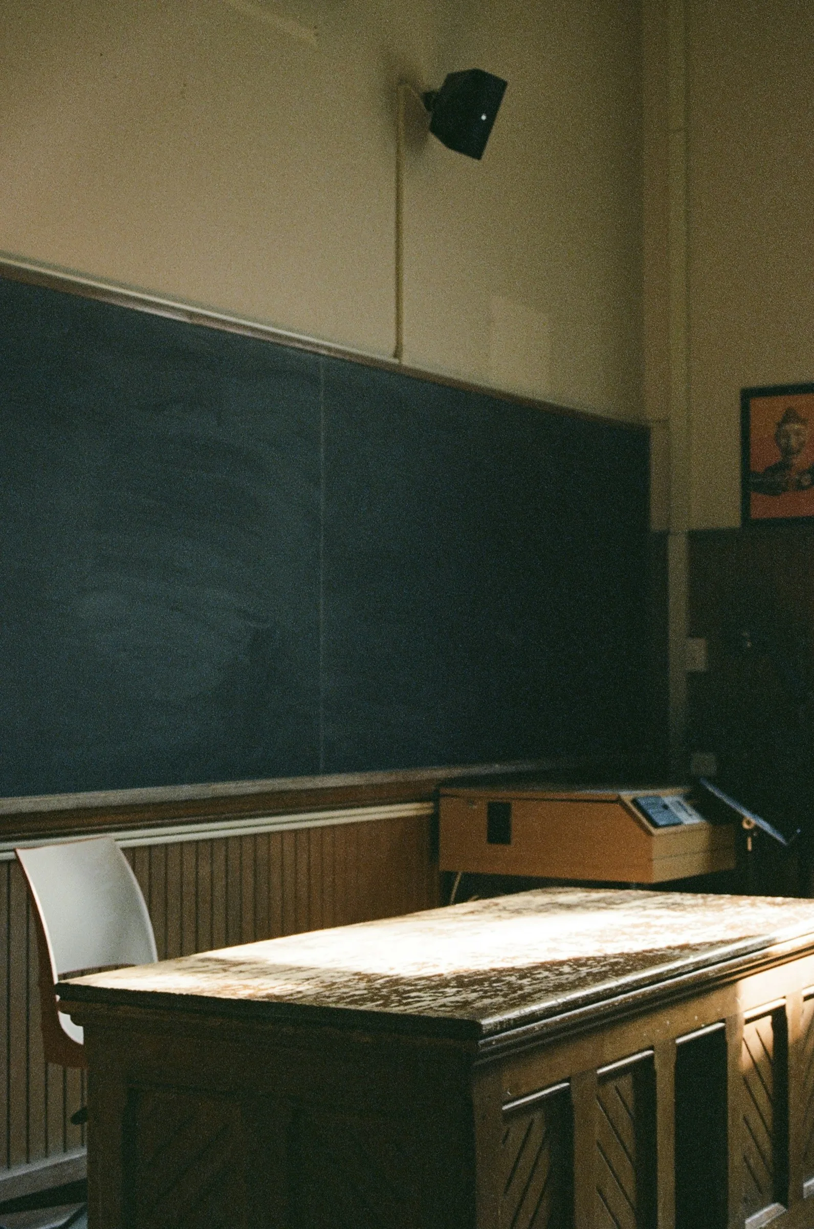 An empty classroom with a chalkboard